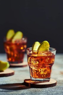 Apple juice whiskey cocktail under hard sunlight