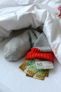Banknotes in stocking under duvet