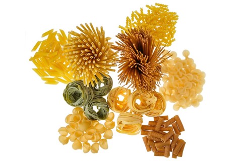Overhead view of various kinds of pasta isolated on white background