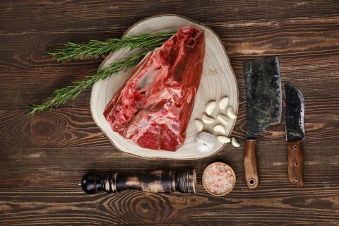 Raw fresh beef shank cross-cut on wooden background