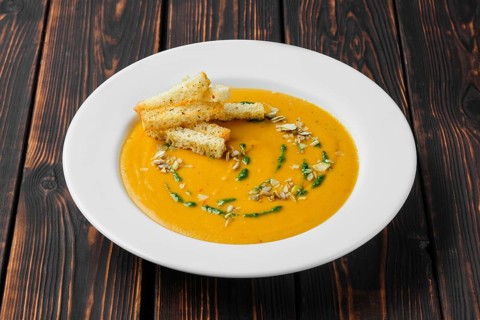Aubergine soup puree with pumpkin seed and crouton