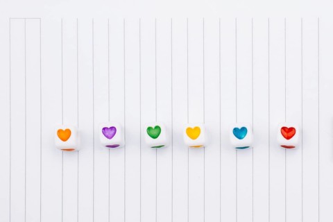 Love cubes and paper arrow on a notebook on canvas