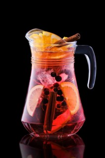 Pitcher with cold sangria isolated on black background