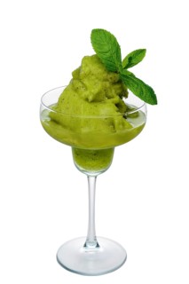 Kiwi smoothie in wide glass decorated with mint leaves isolated on white