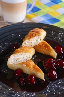 Thin pancakes with curd and cherry jam