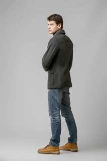 Full length portrait of handsome man in warm woolen coat posing in studio