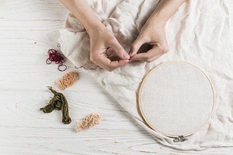 Hand holding needle thread tambour frame