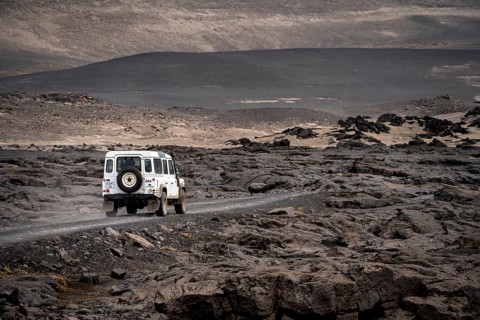 White Land Rover on a dirt road