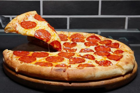 Slice of pizza pepperoni on scapula