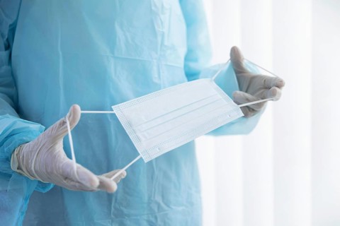 Doctor holding medical mask