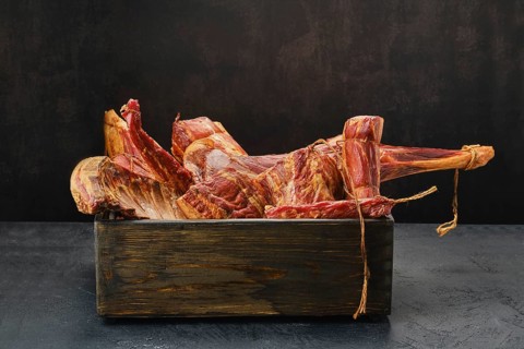 Assortment of air dried and smoked lamb and beef meat in wooden box