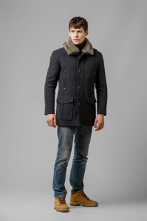Full length portrait of handsome man in warm winter coat posing in studio