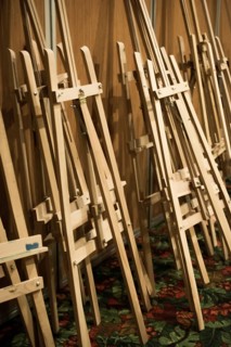 Dozens of of wooden easels in a room
