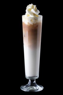 Tall narrow glass with iced coffee isolated on black background