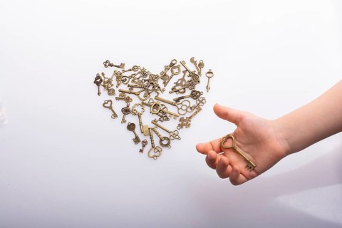 Retro metal keys form a heart shape on white