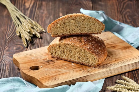 Homemade wheat bread on wooden cutting board