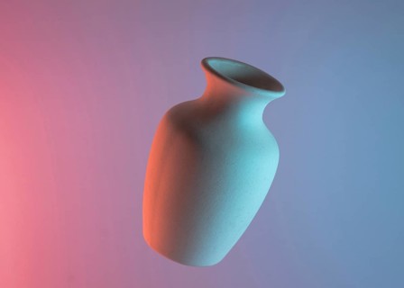 White plain ceramic vase air against colored blue pink backdrop. Resolution and high quality beautiful photo