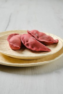 Concept of delivery of semifinished food. Sweet dumplings stuffed with cherry and frozen