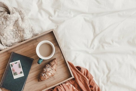Croissant coffee near book bed