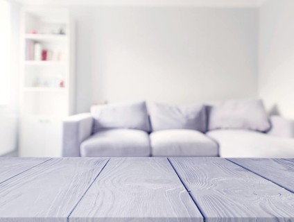Gray wooden table front blur white sofa living room