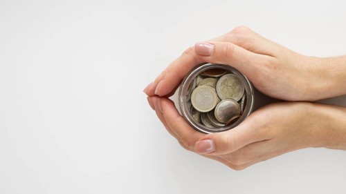 Person holding jar with coins