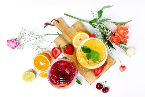 Two wine glasses with summer fruit and berry cocktails. Top view