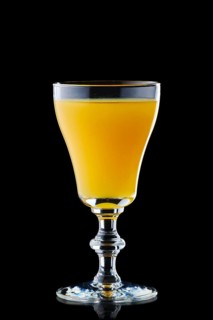 Glass with vodka and orange juice isolated on black background