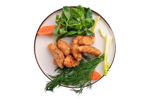 Chicken nuggets in breading isolated on white background