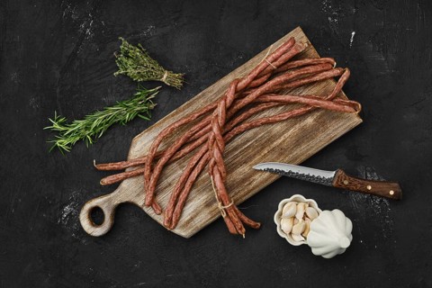Overhead view of long thin homemade beef sausages with garlic