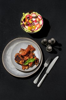 Overhead view of marinated lamb ribs baked in oven