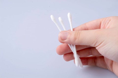 A few ear sticks in hand isolated on white background