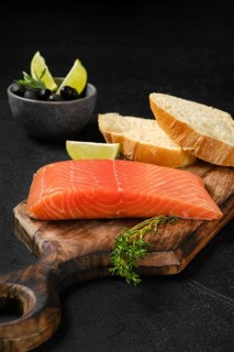 Piece of fresh salmon steak with ciabatta and spicy herb sauce
