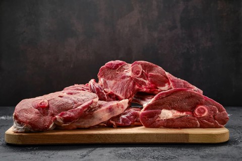Assortment of raw fresh lamb meat on wooden tray