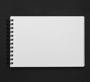Elevated view spiral notepad black background