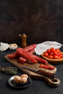 Air dried turkey sausage. Rustic lunch with eggs and tomato