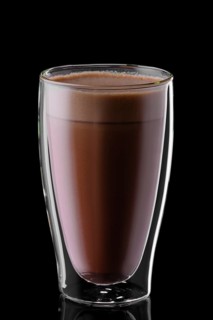 Double wall glass of hot chocolate isolated on black background