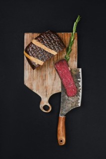 Top view of slice cured beef ham on cutting board