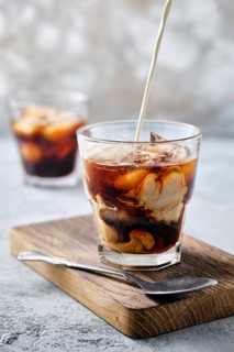 Pouring cream in iced coffee