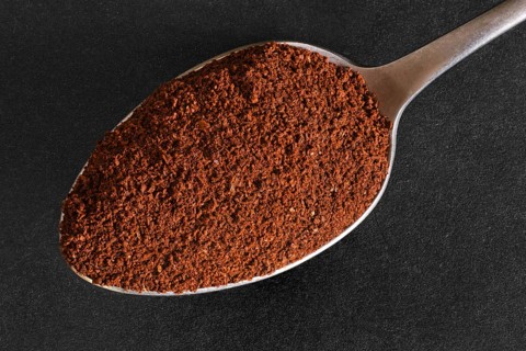 Macro photo of spoon with ground coffee