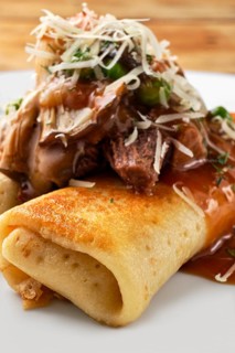 Macro photo of thin pancakes stuffed with beef and mushrooms