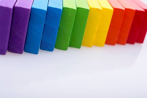 Colorful Domino Blocks in a line on a white background