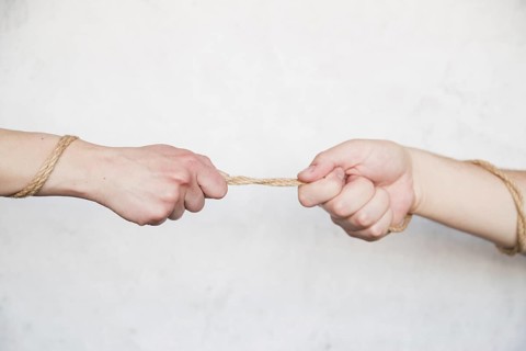 Hands pulling rope
