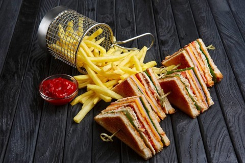 Club-sandwich with french fries in metal basket