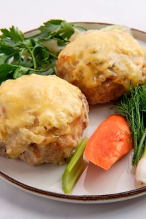 Cutlet covered with melted cheese served with fresh carrot