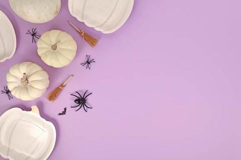 Halloween party flat lay with pumpkin shaped plates
