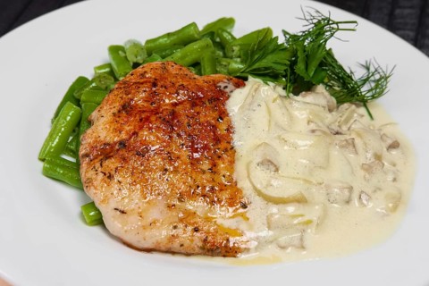 Closeup grilled steak and french green bean with creamy onion sauce