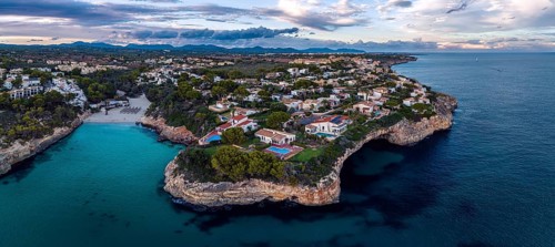 Sunset over Cala Anguila-Cala Mendia from a drone