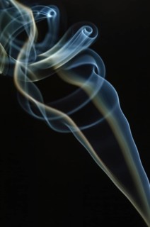 Trajectory of incense smoke in the air showing different shapes. France