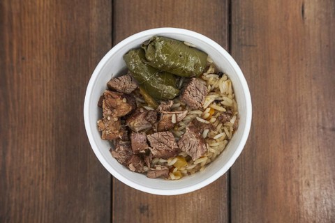 Soft focus photo of dolma and fried meat in take away plate
