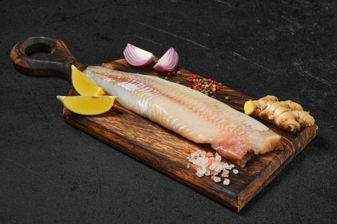 Frozen zander fillet on cutting board